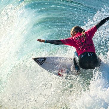 Sally Fitzgibbons flying over a wave
