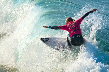 Sally Fitzgibbons flying over a wave