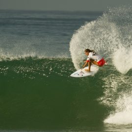 Chelsea Roett making spray off a wave