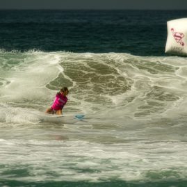 Chelsea Roett setting up to hit the lip of a wave