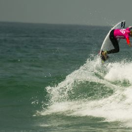 Courtney Conlogue getting air off a wave at the 2016 Supergirl Pro