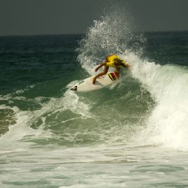 Melanie Giunta dropping down a wave in Oceanside, CA