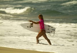 Sage Erickson walks up the beach after her surf contest.