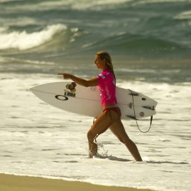 Sage Erickson walks up the beach after her surf contest.