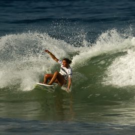 Zoe Mcdougall banks off a wave during a surf contest