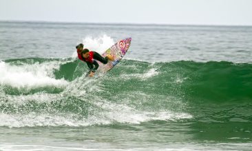 Tyler Wright banks off a medium size wave