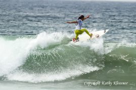 Alessa Quizon surfing strong on the lip of a wave