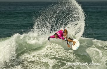 Chelsea Tuach make a large spray on a wave