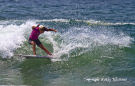 Paige Hareb splashes of a wave
