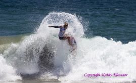 Paige Hareb getting air of a wave