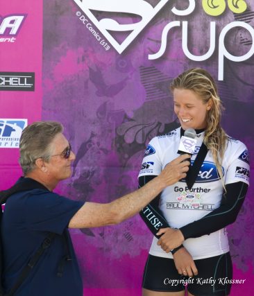 Paige Hareb being interviewed at a surf contest