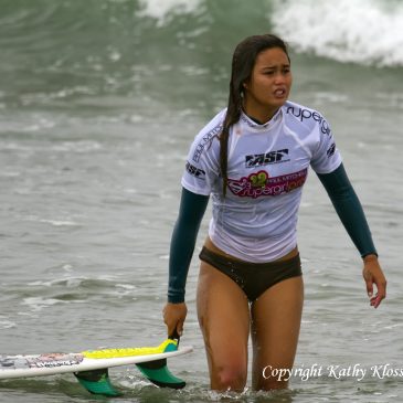 Alessa Quizon holds onto her surfboard