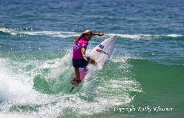 Paige Hareb snaps her board on a wave