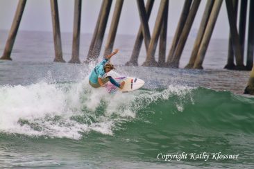 Paige Hareb getting air off a wave near the HB Pier