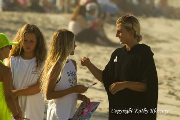 Sage Erickson talks to a young female surf fan.