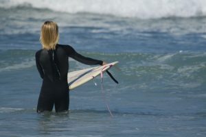 A young girl checks out the surf conditions