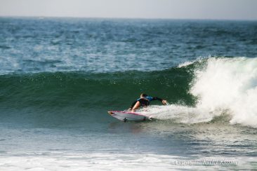 Carissa Moore does a bottom turn on a wave.